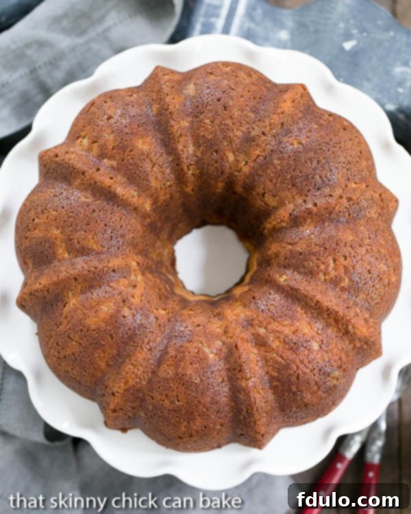 A top-down view of the Apple Bundt Cake with a surprise cream cheese filling, showing its intricate fluted design.