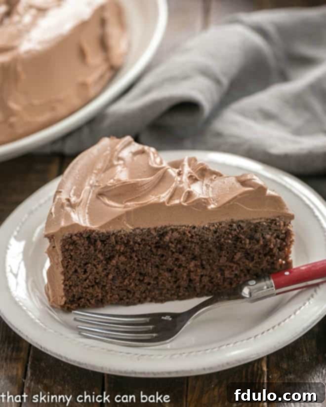 A moist and tender one layer mocha cake with an exquisite, silky chocolate Swiss Meringue Buttercream Frosting Slice of a One Layer Mocha Cake on a white dessert plate with a fork