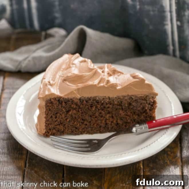 Simple Mocha Indulgence 2 One Layer Mocha Cake on a white plate with a red handled fork