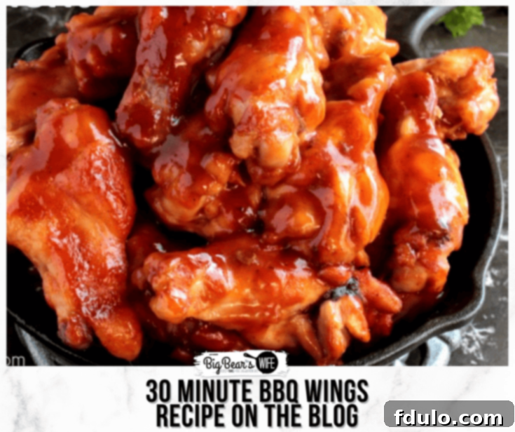 Effortless School Year Meals 14 Close-up of golden-brown BBQ wings, glistening with sauce and garnished with fresh herbs.
