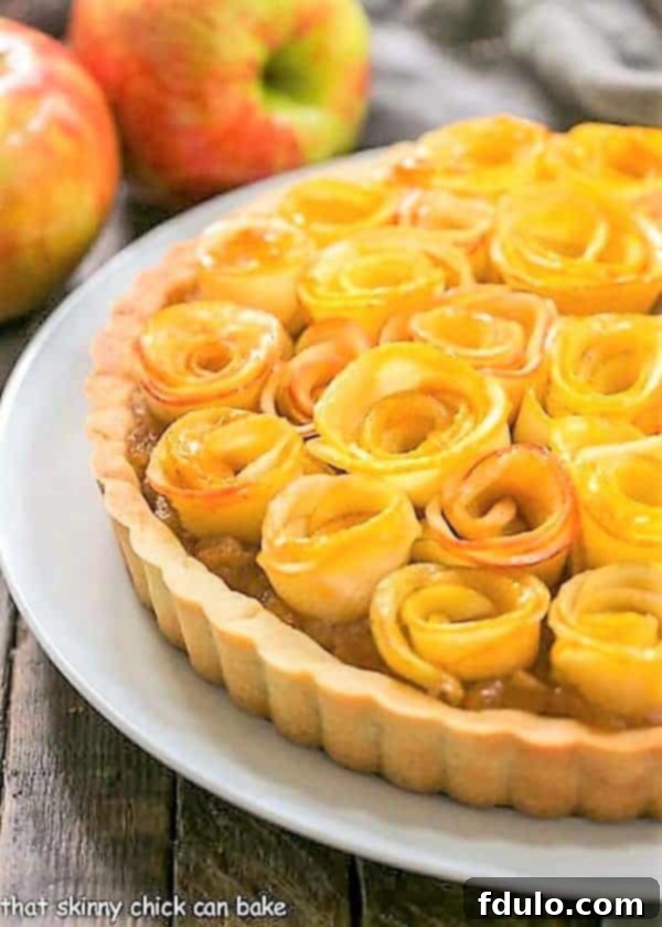 Rosette Apple Tart on a white plate, showcasing the intricate apple rose topping.