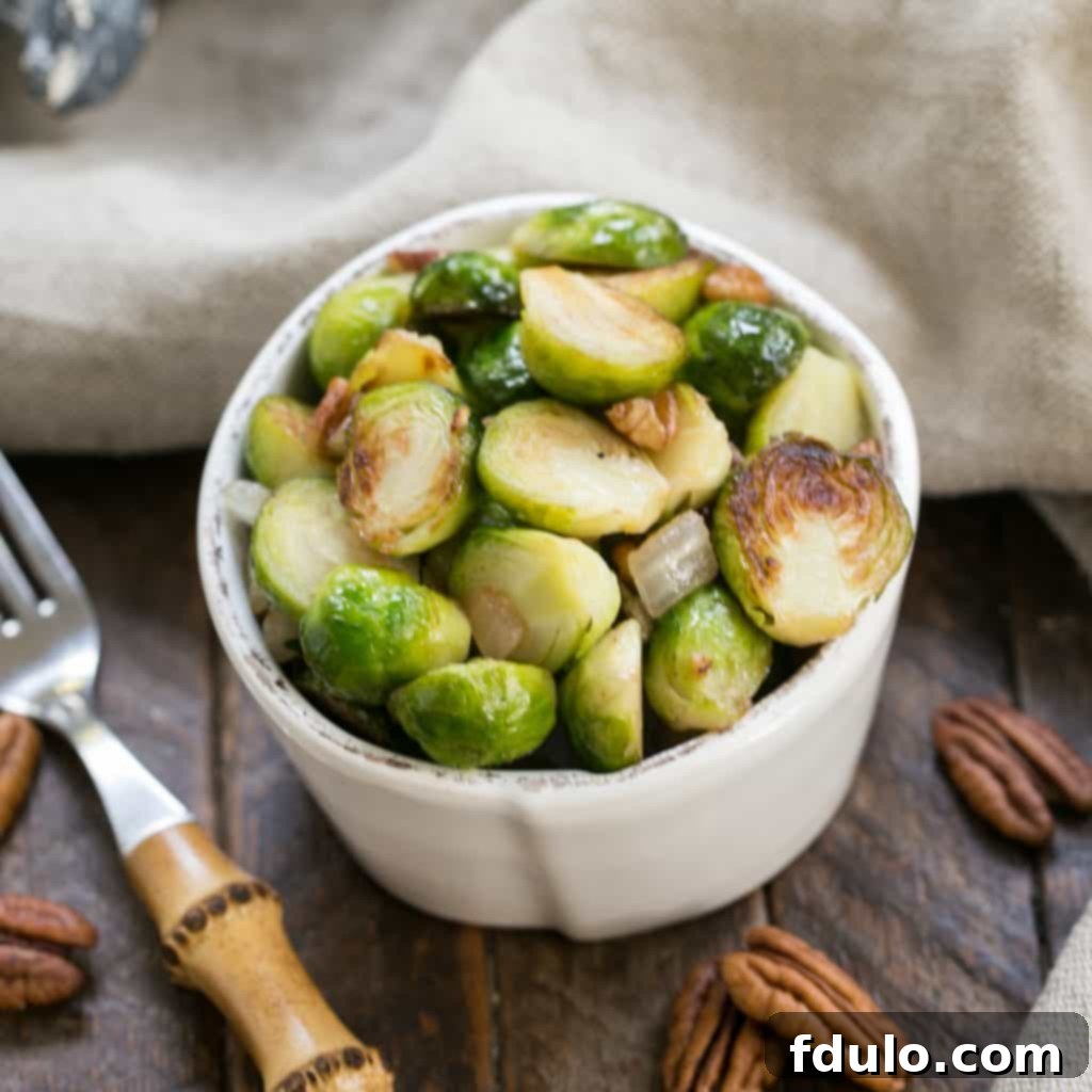 Overhead view of a small white bowl of sauteed Brussels sprouts
