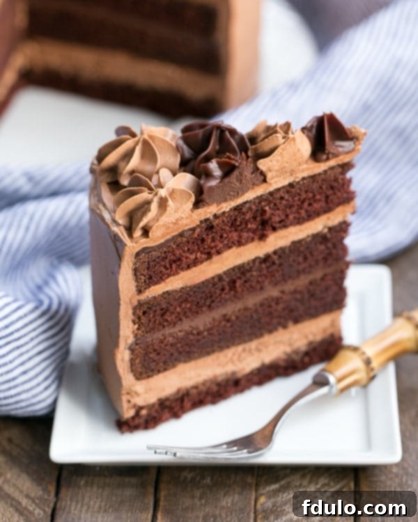 Chocolate Fudge Layer Cake slice on a square white plate.