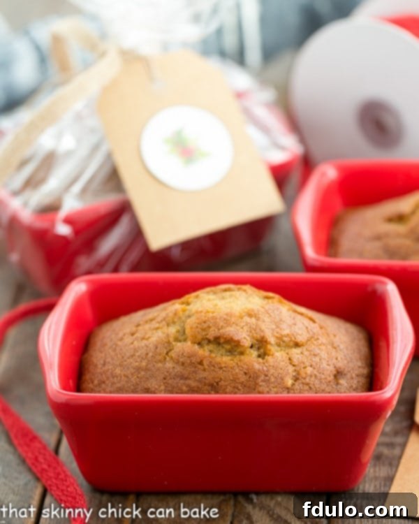 Mini Pumpkin Breads in a small red ceramic loaf pan.