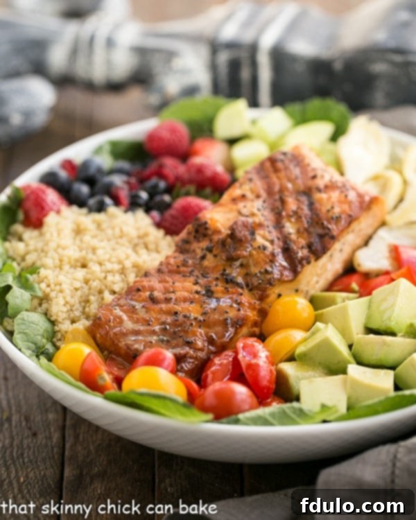 A beautifully arranged Superfoods Salad in a pristine white bowl, showcasing vibrant ingredients.
