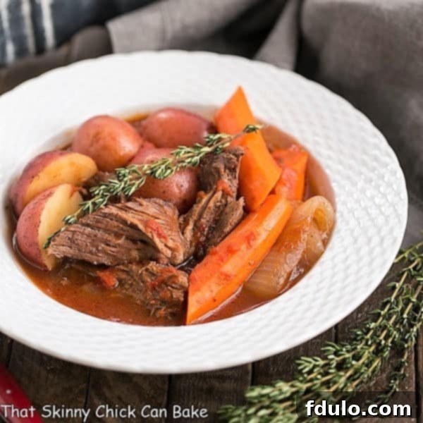 Easy Pot Roast in a white bowl with thyme to garnish and thyme next to the bowl.