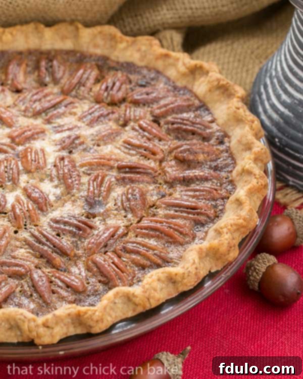 Classic Pecan Pie, with a boozy twist! - A rich, ultra-sweet indulgence. Perfect for the holidays! Classic Pecan Pie, spiked with bourbon in a pastry crust on a red napkin.