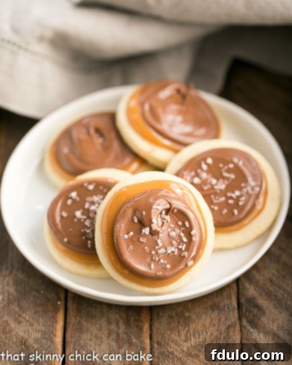 Individually crafted Chocolate Caramel Shortbread Cookies arranged elegantly on a pristine round white plate, ready to be enjoyed.