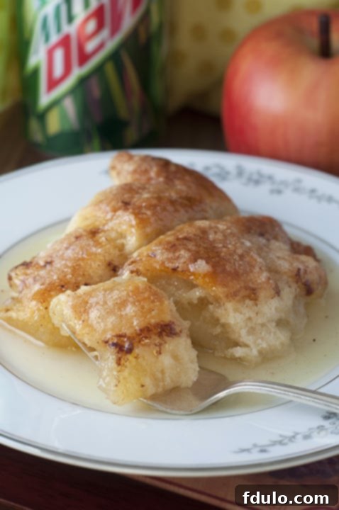 Cinnamon Apple Dumplings, baked apples wrapped in pastry with a sweet cinnamon sauce, a comforting dessert.