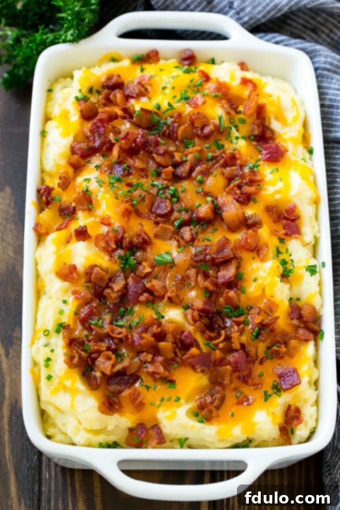 Mashed Potato Casserole, a comforting side dish loaded with cheese, bacon, and chives, baked to perfection.