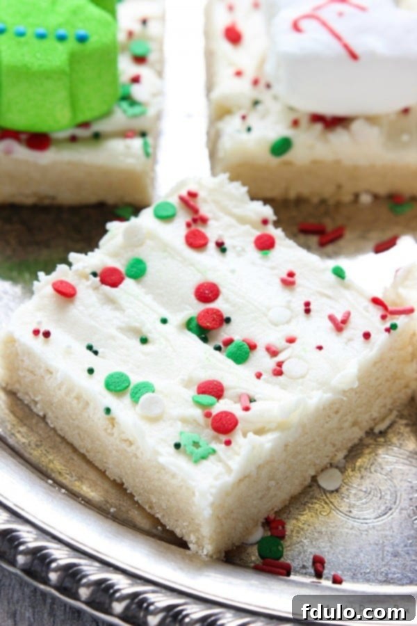Eggnog Sugar Cookie Bars, chewy cookie bars flavored with eggnog and topped with festive frosting.