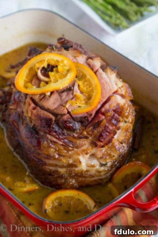 Tangerine Glazed Ham, a succulent holiday ham coated in a bright, zesty tangerine glaze.