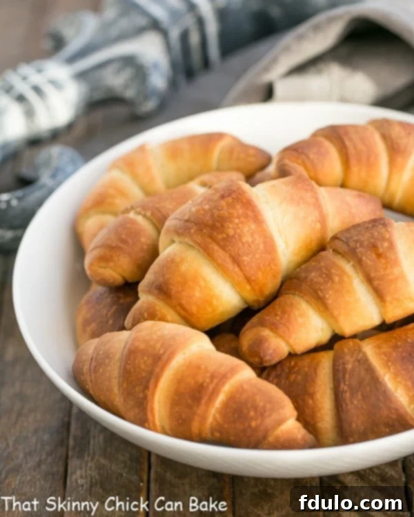 Buttery Homemade Crescent Rolls in a white serving bowl.