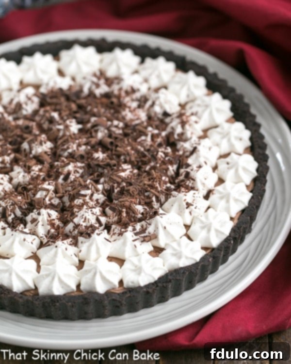 French Silk Tart - Rich, satiny smooth chocolate filling in an Oreo crust French Silk Tart on a white serving plate.