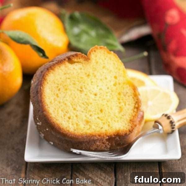 A slice of Easy Lemon Bundt Cake elegantly placed on a square ceramic dessert plate, ready to be enjoyed.