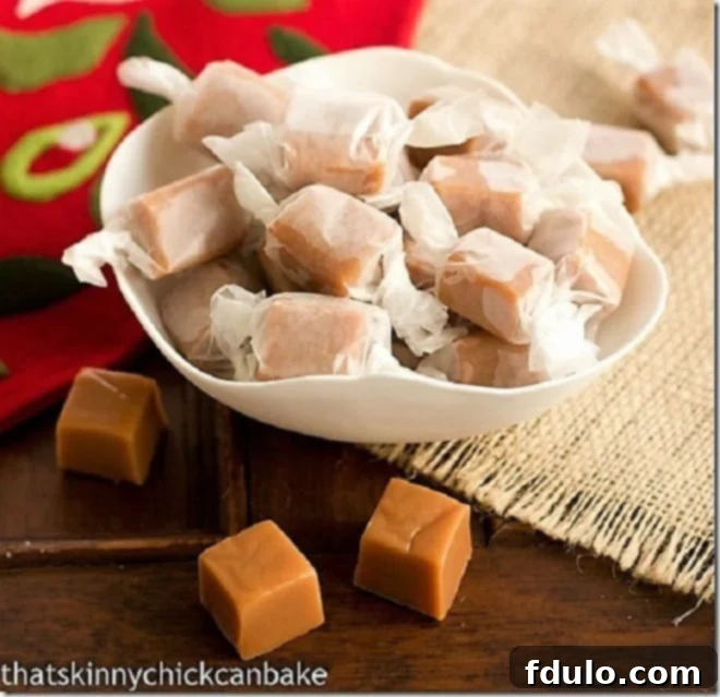 Individual Brown Sugar Caramels, perfectly wrapped in wax paper, nestled in a pristine white bowl, showcasing their golden-brown hue and delicious promise.