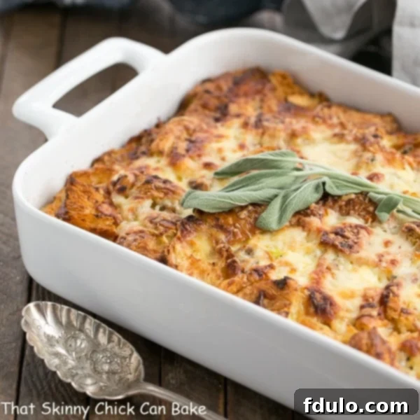 Sausage Croissant French Toast Casserole baking in a pristine white ceramic dish, showcasing its golden edges and bubbly cheese.