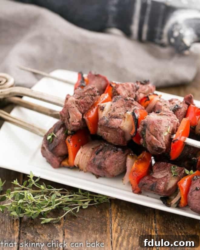 Greek Marinated Lamb Kebabs on a white serving tray, beautifully arranged.