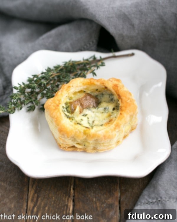 Potato Blue Cheese Tartlets are an easy, elegant and hearty appetizer! A single, perfectly baked Potato Blue Cheese Tartlet resting on an elegant appetizer plate, showcasing its golden crust and delicious filling.