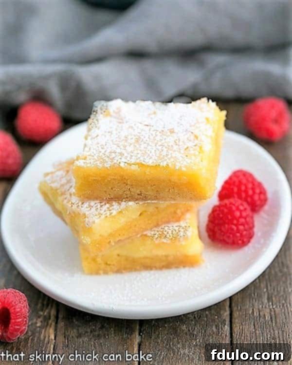 Stack of Gooey Butter Bars on a dessert plate.