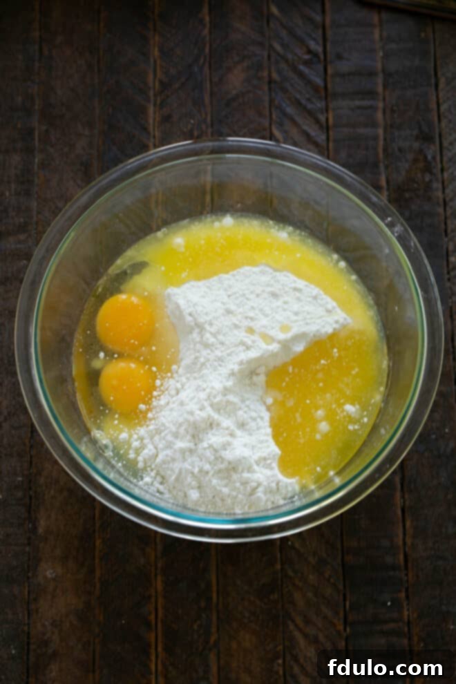 Add cake mix, butter and eggs to bowl.