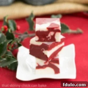 Square pieces of scrumptious red velvet fudge, showing its vibrant color and smooth texture.