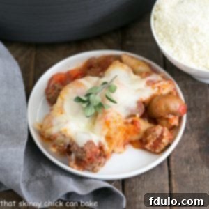 Overhead view of a small white plate with Cavatini Supreme topped with an herb sprig, perfectly portioned for a single serving.