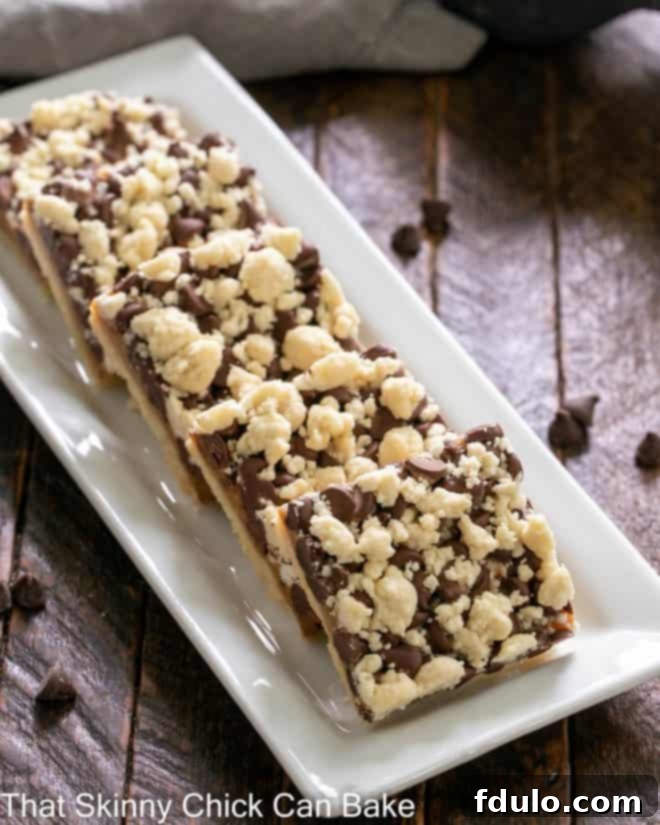 A selection of chocolate caramel streusel bars arranged artfully on a white ceramic tray, showcasing their layered beauty.