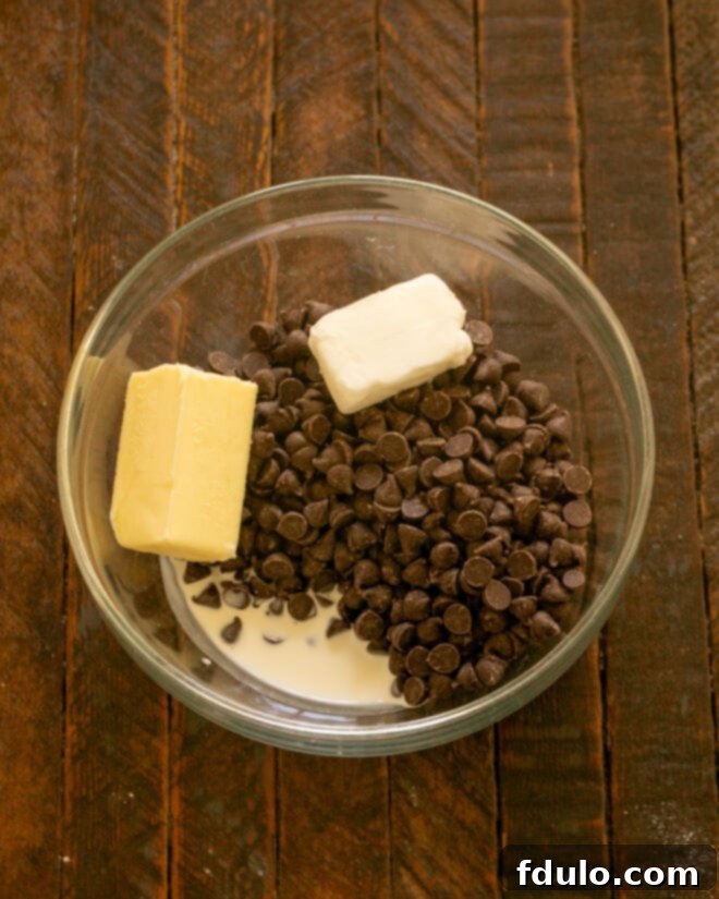 Ingredients for chocolate ganache in a microwave-safe bowl.