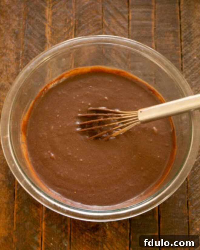 Brownie batter being mixed in a bowl.