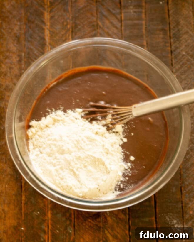Flour being added to brownie batter.