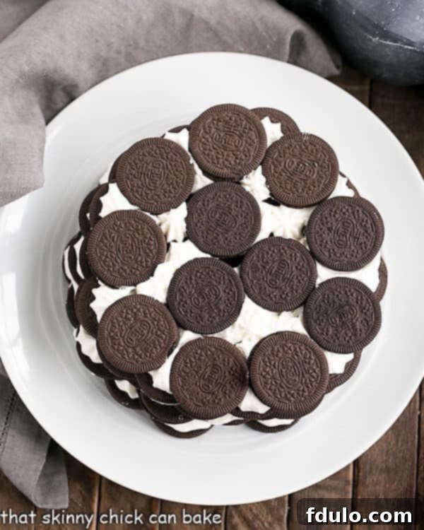Oreo Icebox Cake - Minimal ingredients and effort to make this marvelous no-bake dessert Overhead view of a perfectly layered Oreo Icebox Cake on a white plate with a gray napkin, showing its beautiful contrast.
