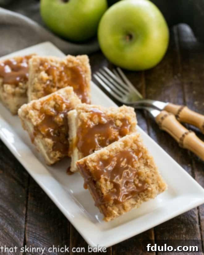 Caramel Apple Bars on a white ceramic plate with 2 forks