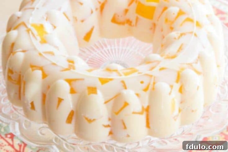 Vibrant Orange Creamsicle Jello Mold Salad, a cool and easy dessert.