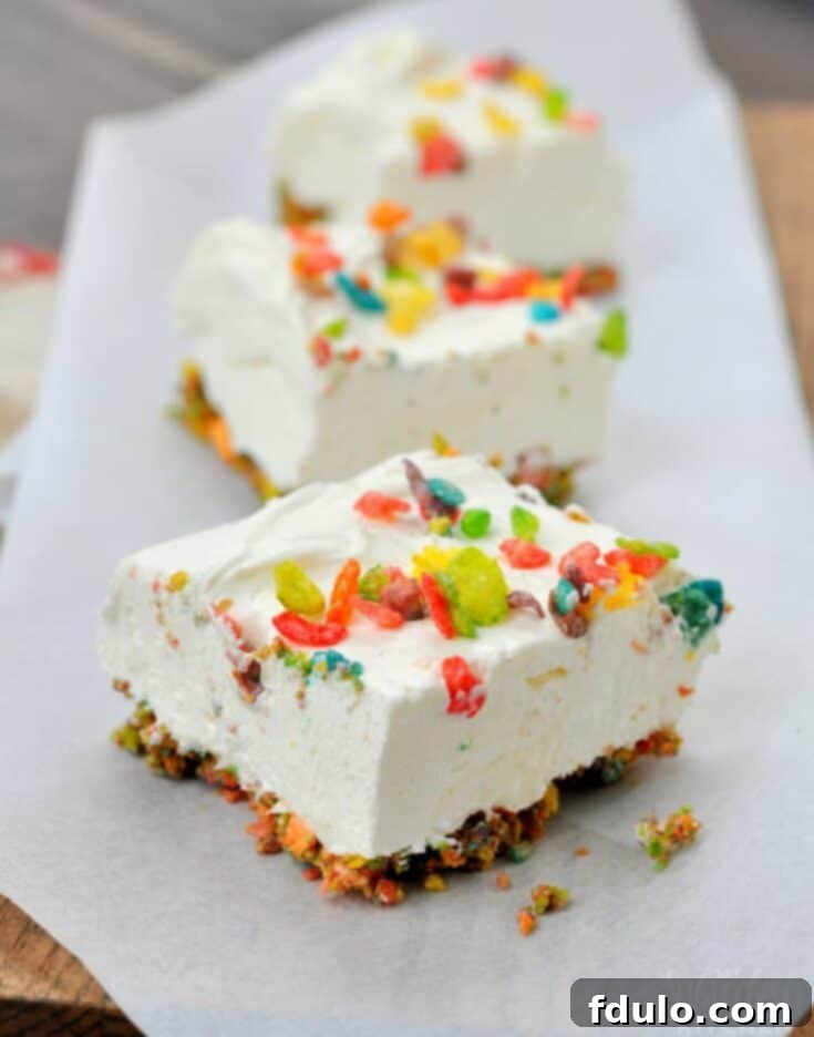 Colorful Fruity Pebbles No Bake Cheesecake Bars, a fun celebratory dessert.