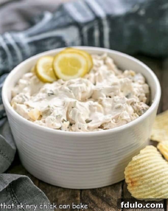 Easy Dill Pickle Dip - Get prepared for rave reviews from this Easy Dip Recipe! Only 5 ingredients! Easy Dill Pickle Dip in a white bowl garnished with pickle slices. A perfect creamy and tangy appetizer for any occasion.