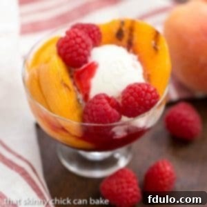 Grilled Peach Melba with ice cream and raspberry sauce