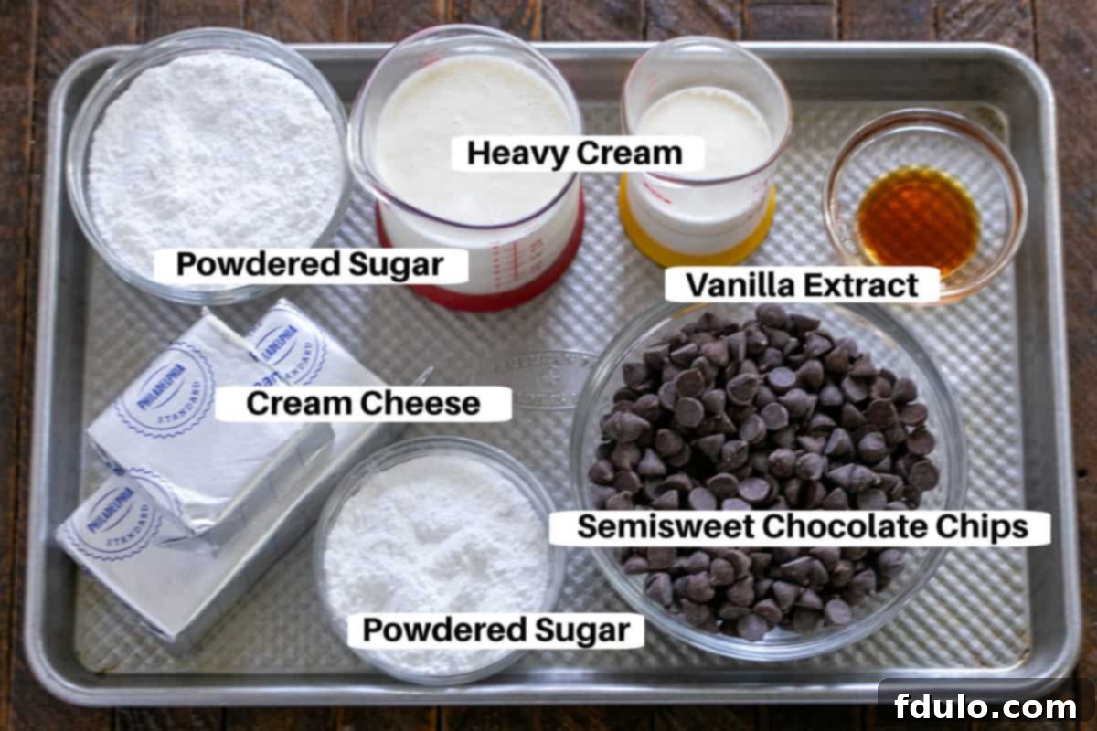 Ingredients for the chocolate cream pie filling, including cream cheese, powdered sugar, semi-sweet chocolate chips, and heavy cream, presented on a metal sheet pan.