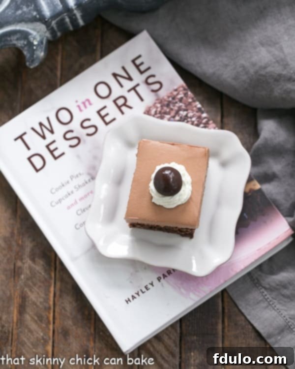 A stunning French Silk Pie Brownie artfully placed on a plate, resting beside Haley Parker's innovative 'Two in One Desserts' cookbook.