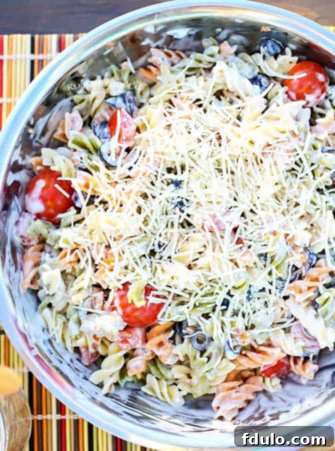 Parmesan Ranch Pasta Salad, a delicious potluck salad with olives, bacon, tomatoes, and pasta.