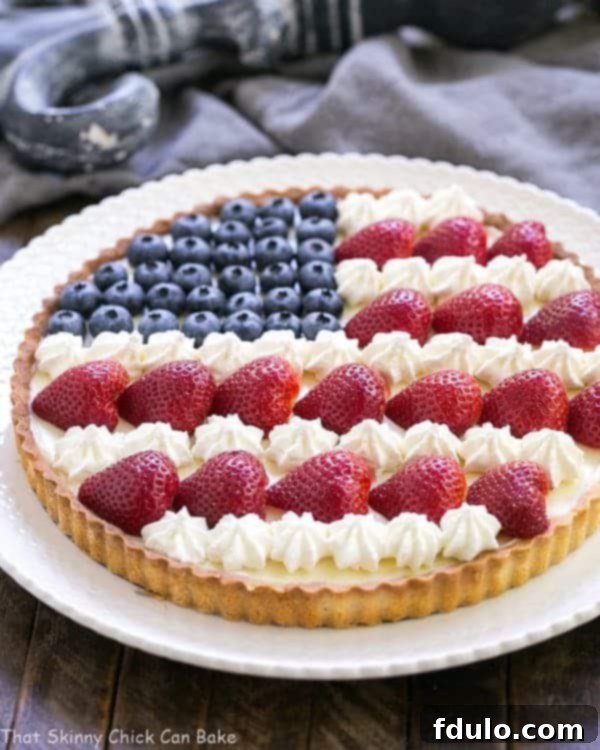 American Flag Fruit Tart on a white serving plate, beautifully presented.