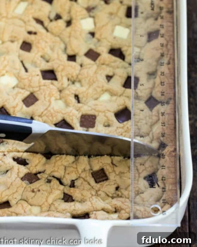Bar cookies neatly arranged on a cutting board, accompanied by a sharp knife and a ruler, signifying readiness for precise and uniform slicing.