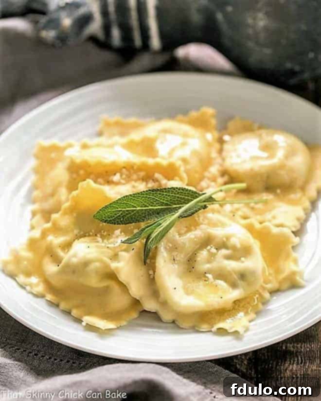 Ravioli on a white plate with sage leaves to garnish