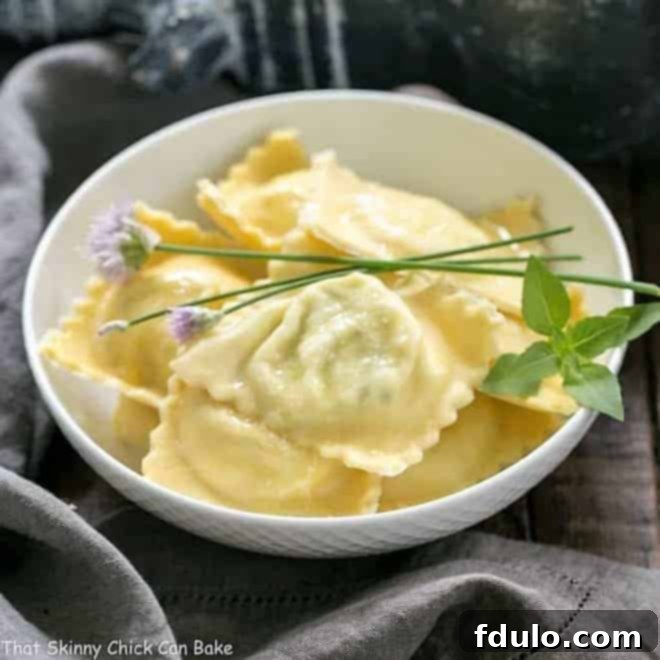 Bowl of Mozzarella, Basil, Parmigiano-Reggiano Ravioli with Butter Sage Sauce garnished with fresh basil and chives