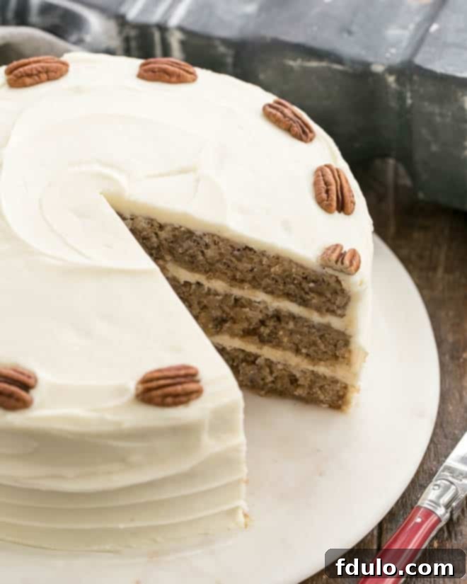 Moist and Flavorful Hummingbird Cake 2 Hummingbird Banana Cake with a slice removed.