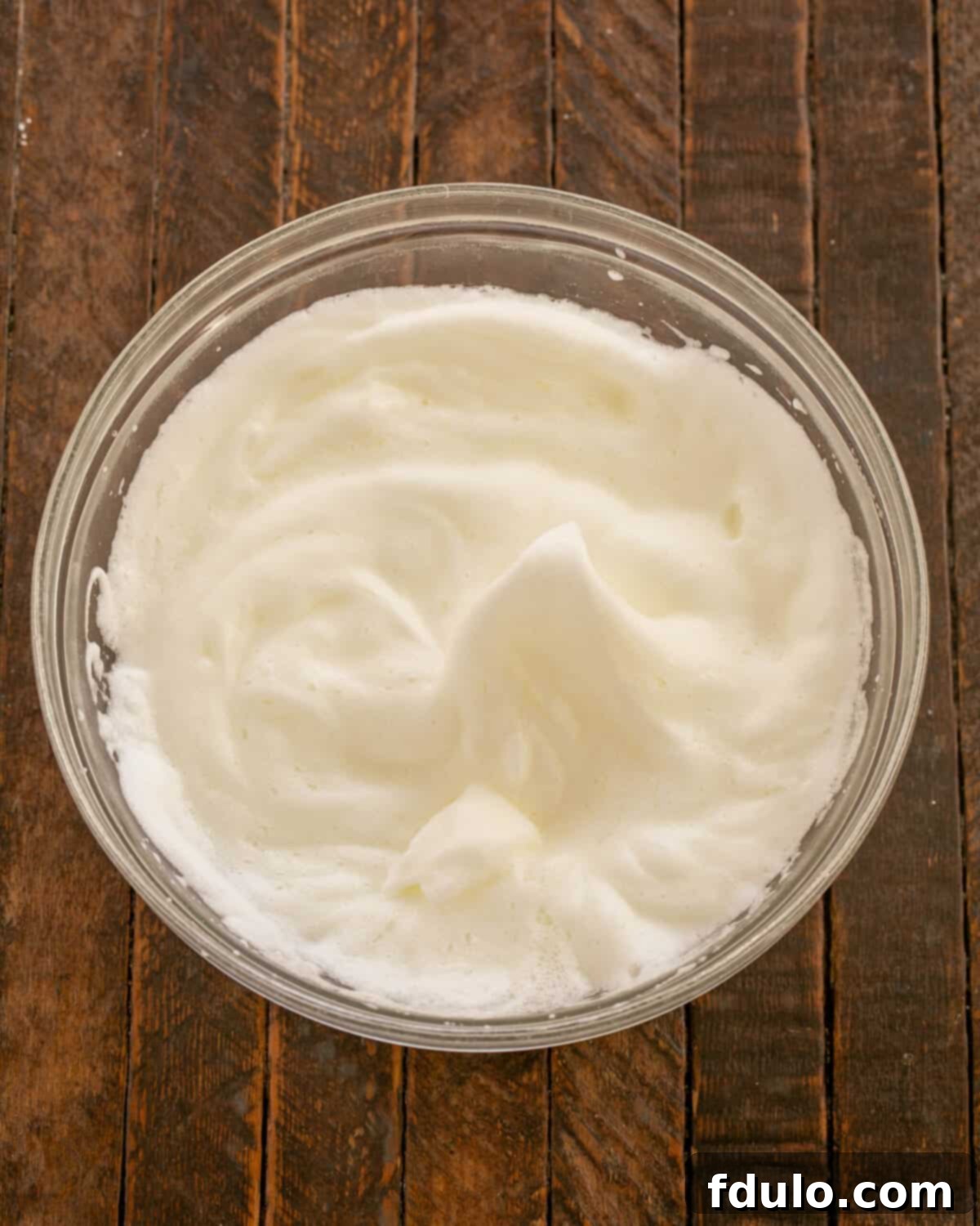 Beaten egg whites in a clean mixing bowl.