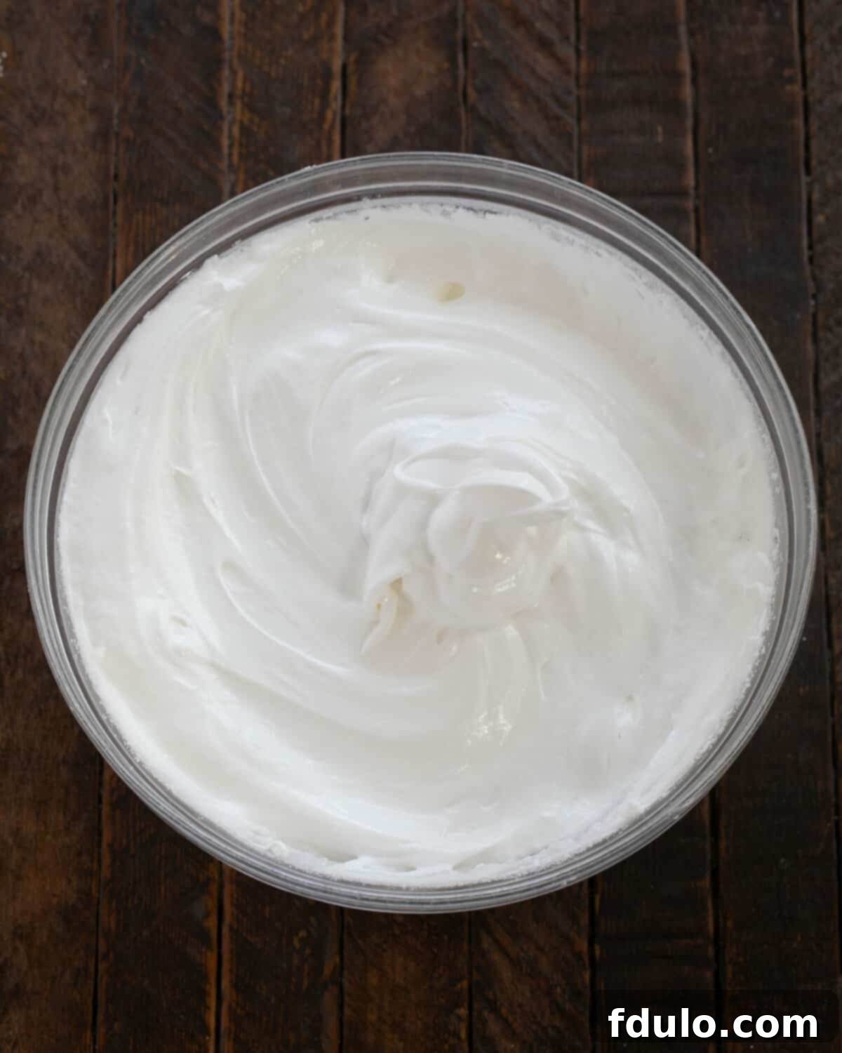 Egg whites beaten with superfine sugar, forming stiff, glossy peaks.