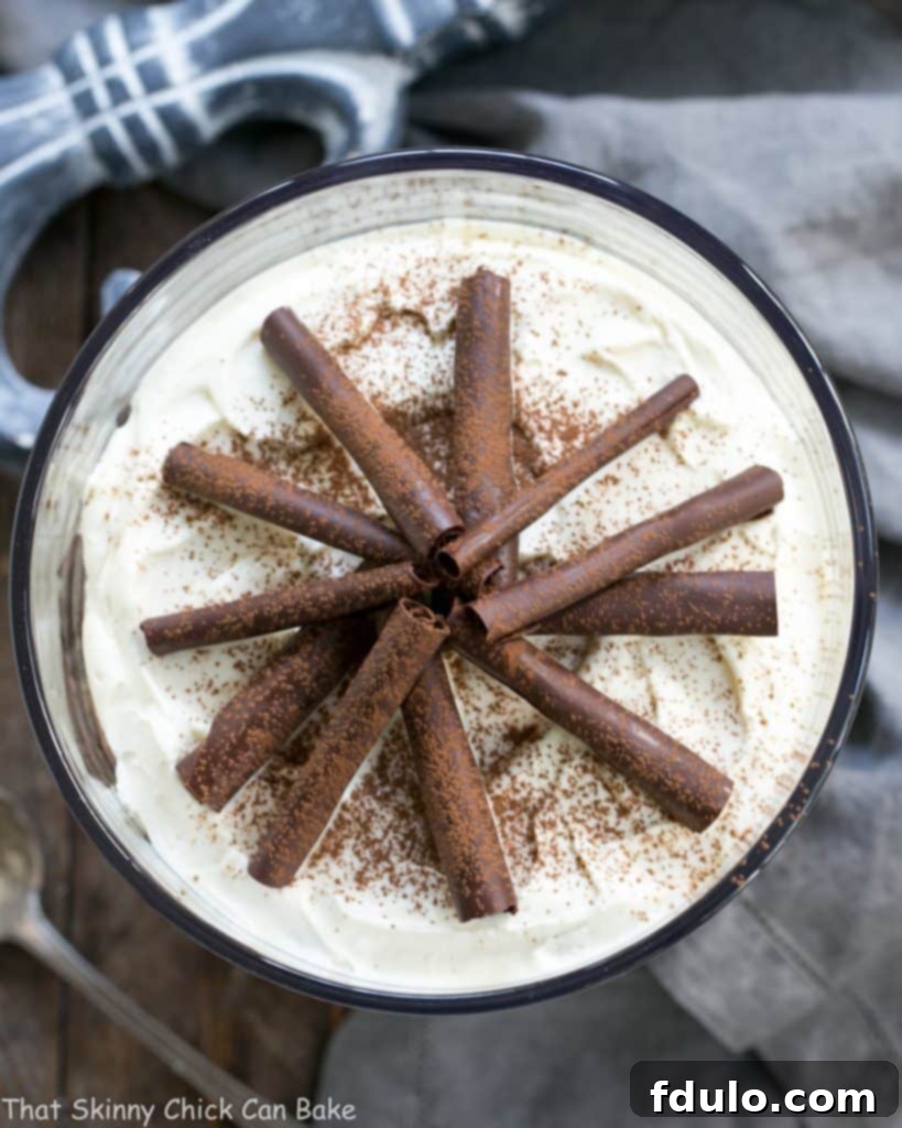 Fudgy Brownie Trifle with Chocolate Mousse - 3 outrageously delicious layers plus chocolate curls! An inviting overhead view of a Fudgy Brownie Trifle, lavishly topped with delicate chocolate curls, showcasing its irresistible layers of brownies and creamy chocolate mousse.