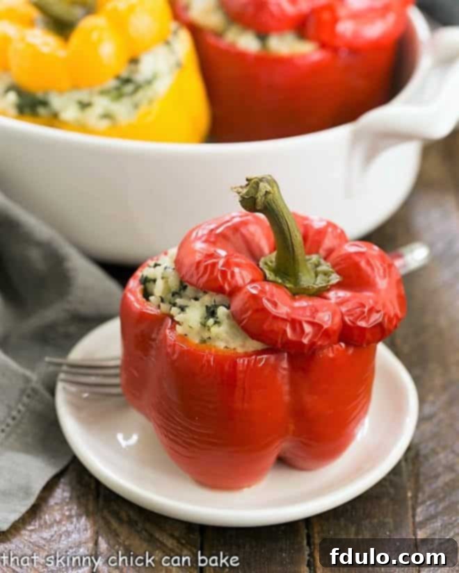 Beautifully baked Rice Packed Peppers on a white serving plate, garnished with fresh herbs.