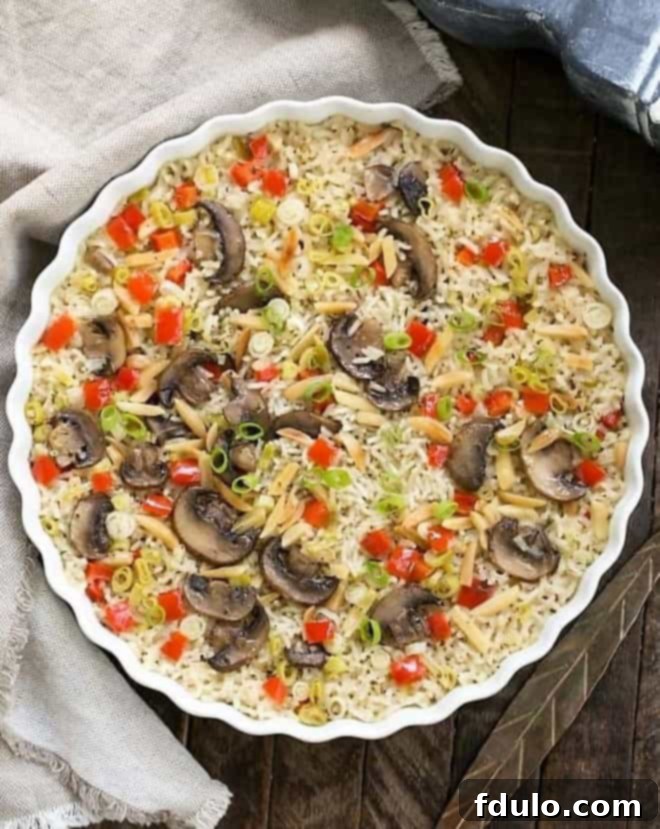 Overhead view of baked rice pilaf in a round dish.